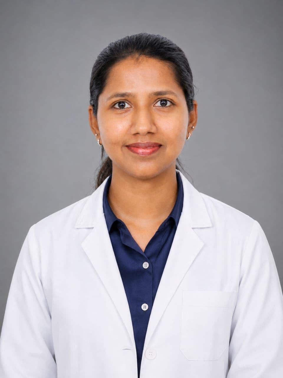 Dr. Bhavana, professional headshot in a white coat